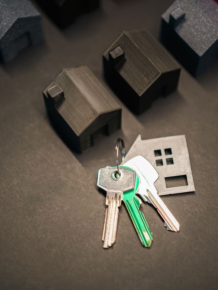 House keys and model homes on a closing table