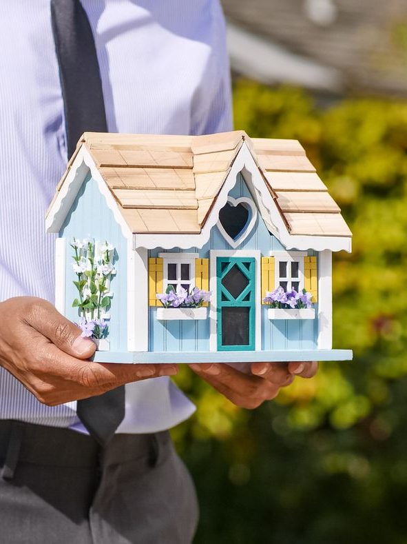 A client holding a model of their new home